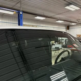 Tinted window seen from outside, with the interior behind it.